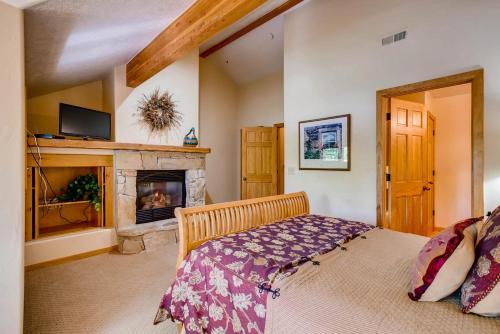 a bedroom with a bed and a fireplace at Foxglove Condos in Park City
