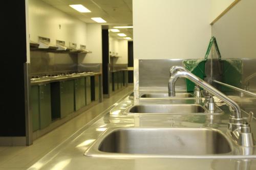 a kitchen with three sinks in a kitchen at Résidences Université Laval in Quebec City