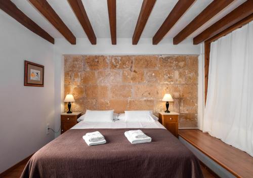a bedroom with a bed and a lamp at Ramón Llull House in Palma de Mallorca