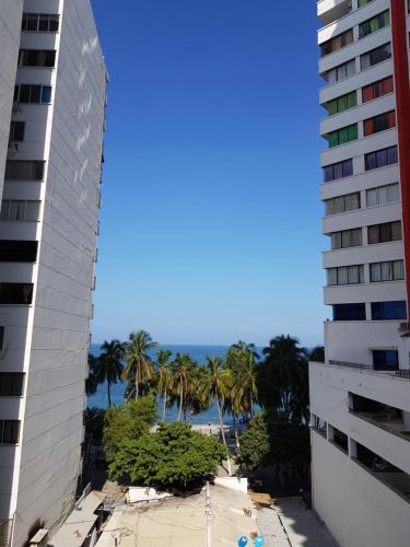 una vista sulla spiaggia dal balcone di un edificio di Apartamentos Playa Rodadero a Santa Marta