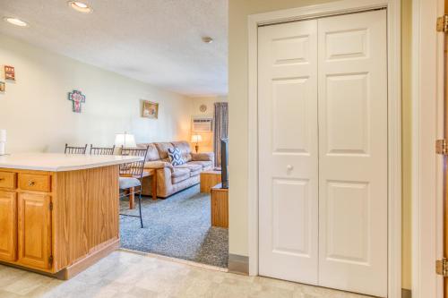 a kitchen and living room with a white door at Misty Harbor Resort in Gilford