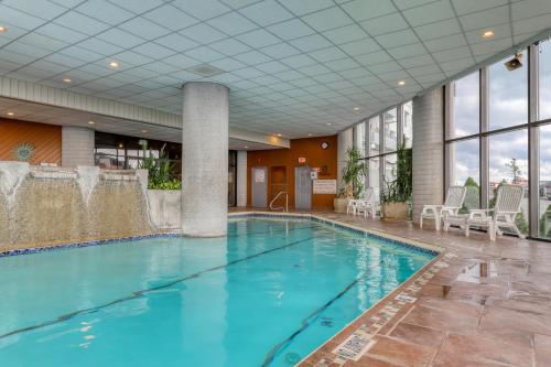 a large swimming pool in a hotel lobby with blue water at Sugar Top Condos in Sugar Mountain