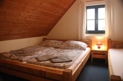 a bedroom with a bed in a attic at Relax Chalet in Cerny Dul