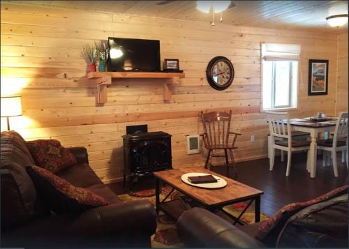 a living room with a couch and a stove at The Ridge At Glacier - Luxury Cabins in Coram