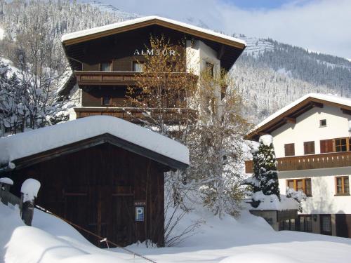a building in the snow with snow on it at Hotel Garni Almjur in Sankt Anton am Arlberg