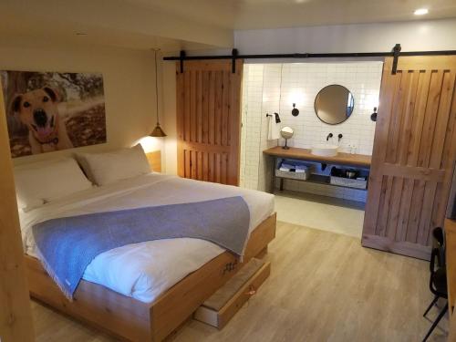 a bedroom with a bed and a bathroom with a sink at Best Friends Roadhouse and Mercantile in Kanab