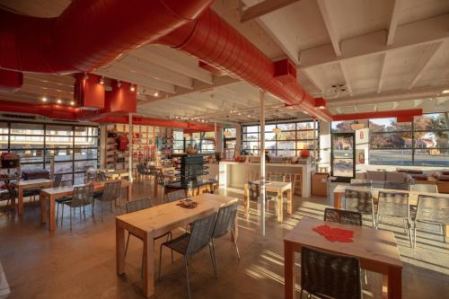 a restaurant with tables and chairs in a room at Best Friends Roadhouse and Mercantile in Kanab