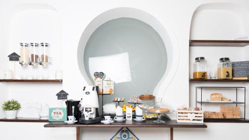 a mirror on a shelf with a coffee maker on a table at Camera Ardea in Aversa