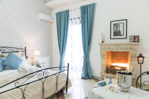 a bedroom with a bed and a fireplace at Camera Ardea in Aversa