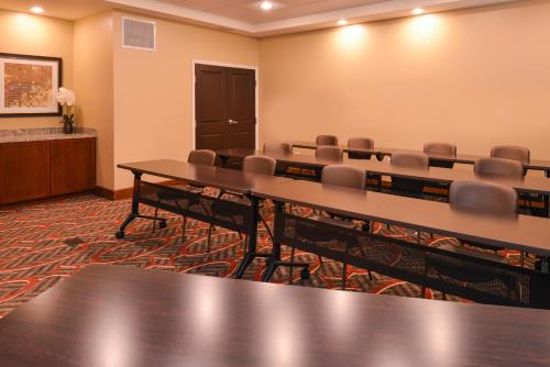a conference room with tables and chairs and a podium at Staybridge Suites Merrillville by IHG in Merrillville