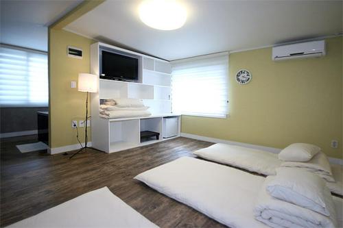 a bedroom with a large bed and a television at Crib 49 Guesthouse - Foreigner only in Seoul