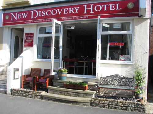 a new discovery hotel with chairs in front of it at MyRoomz New Discovery Hotel in Blackpool
