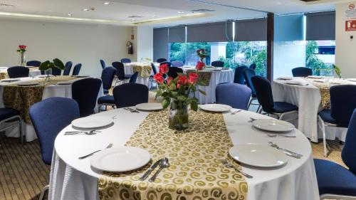 a conference room with tables and chairs and a vase of flowers at Holiday Inn Express Culiacan by IHG in Culiacán