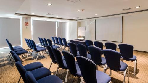 a conference room with chairs and a table and a screen at Holiday Inn Express Culiacan by IHG in Culiacán