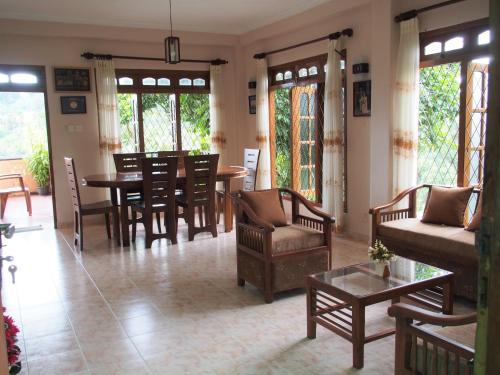 a living room with a table and chairs at Nisha homestay inn in Peradeniya