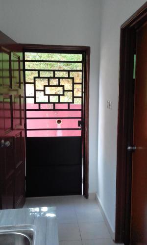 a view of a bathroom with a door with a window at Annx 7 Melati Inn in Kajang