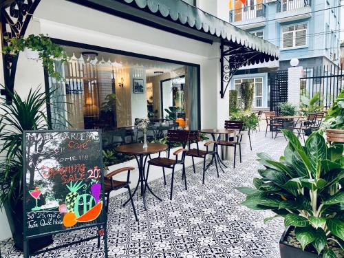 a restaurant with tables and chairs on a patio at Hana Stay Trần Quốc Hoàn in Hanoi