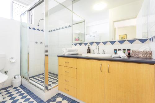 a bathroom with a shower and a sink at Cottesloe Marine Apartment in Perth