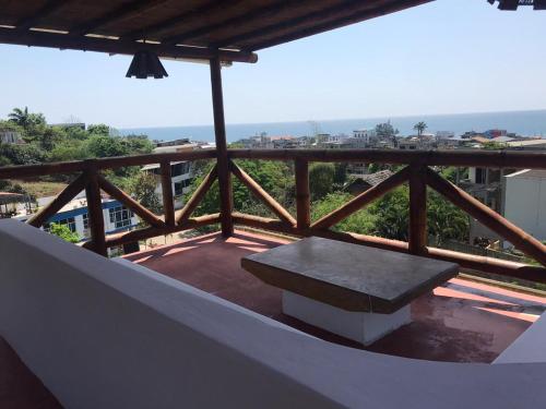 a bench sitting on top of a balcony at The Heights in Montañita in Montañita