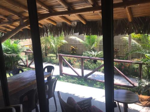 a patio with a table and chairs and a fence at The Heights in Montañita in Montañita