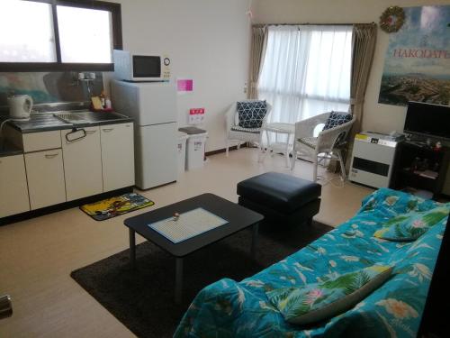 a living room with a couch and a table at Corpo Marika B in Hakodate
