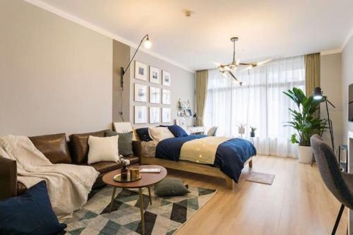 a living room with a bed and a couch at Wuhan Wuchang·Star City· Locals Apartment 00121940 in Wuhan