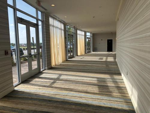 a large room with a walkway leading to a hallway at Holiday Inn Statesboro-University Area, an IHG Hotel in Statesboro