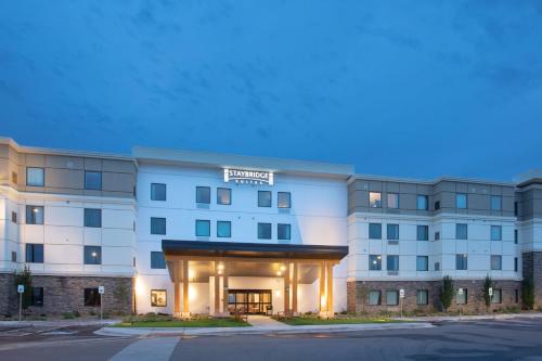 a large white building with a sign on it at Staybridge Suites Denver South - Highlands Ranch by IHG in Littleton