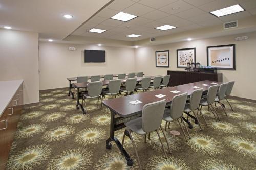 a conference room with a long table and chairs at Staybridge Suites Denver South - Highlands Ranch by IHG in Littleton