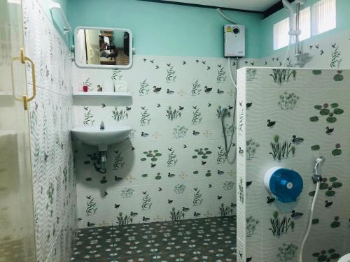 a bathroom with a shower and a sink at Khao Sok Blue Mountain in Khao Sok