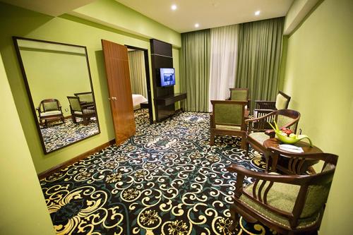 a hotel room with a large room with a hotel room at Mudzaffar Hotel in Melaka