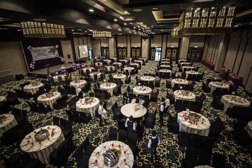 a room full of tables and chairs in a banquet hall at Mudzaffar Hotel in Melaka