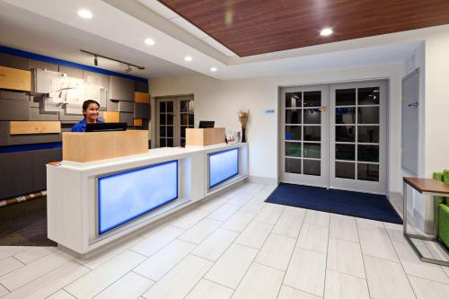 a man standing at a reception desk in an office at Holiday Inn Express Hotel & Suites San Diego-Escondido by IHG in Escondido
