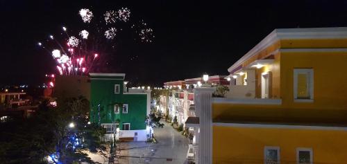 a view of a city with fireworks at night at Inn巷文創旅店 Inn siang B&B-墾丁夢幻島 in Sigou