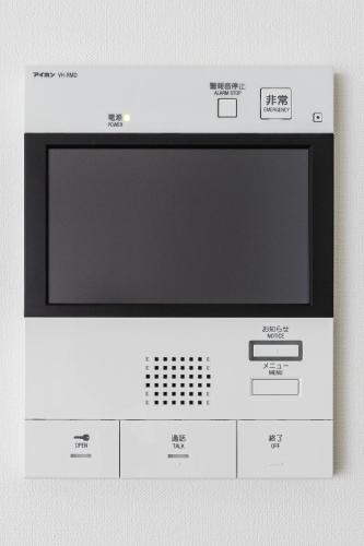 a microwave oven sitting on top of a wall at Ostay Shin-Osaka Hotel Apartment in Osaka