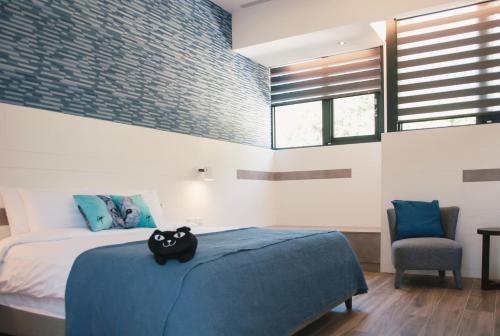 a bedroom with a bed with a black cat pillow on it at Doris Home in Yuchi