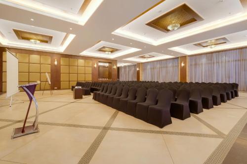 a conference room with a row of chairs and a podium at The Fern An Ecotel Hotel, Lonavala in Lonavala