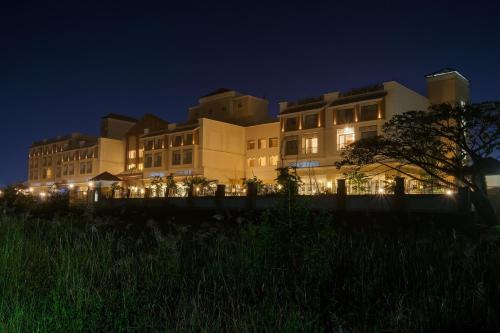 a large building at night with lights on at The Fern An Ecotel Hotel, Lonavala in Lonavala