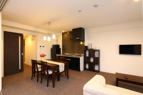 a kitchen and living room with a table and chairs at Marina Sunrise Osaka Bay in Osaka