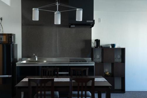 a kitchen with a sink and a table with chairs at Marina Sunrise Osaka Bay in Osaka