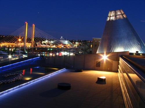 a view of a bridge and a building at night at Hilton Garden Inn Tacoma Downtown in Tacoma