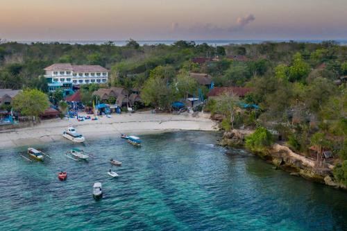 an aerial view of a beach with boats in the water at The Tanis Beach Resort Nusa Lembongan in Nusa Lembongan