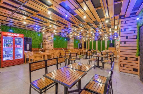 a restaurant with tables and chairs and a soda machine at Sea Pearl Cat Ba Hotel in Cat Ba