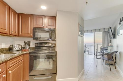 a kitchen with a stove and a microwave at Ocean-Front Condos at Patricia Grand in Myrtle Beach