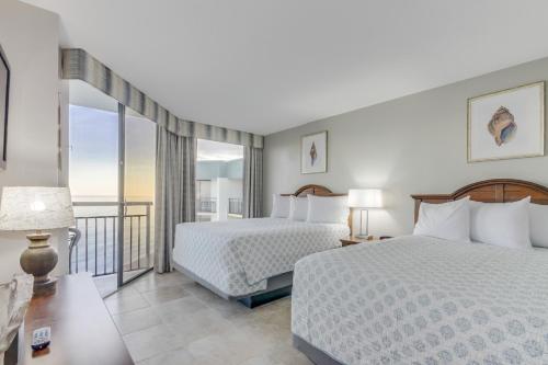 a hotel room with two beds and a balcony at Ocean-Front Condos at Patricia Grand in Myrtle Beach