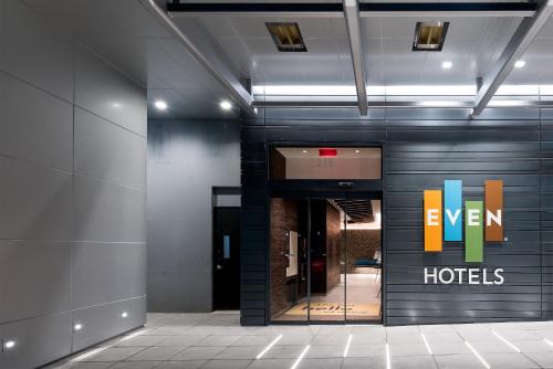 a lobby with a hotel sign on the wall at EVEN Hotel New York - Midtown East by IHG in New York