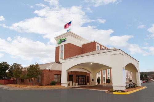 a building with an american flag on top of it at Holiday Inn Express Fredericksburg - Southpoint by IHG in Fredericksburg
