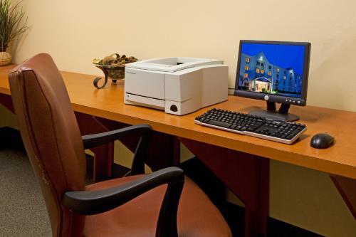 a desk with a computer and a printer on it at Candlewood Suites Melbourne/Viera by IHG in Melbourne