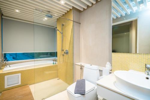 a bathroom with a toilet and a sink and a shower at Baycliff Residence by Lofty in Patong Beach