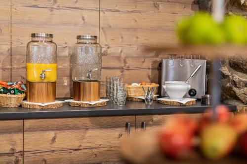 two glass jars of orange juice on a counter at Roggenstock Lodge in Oberiberg